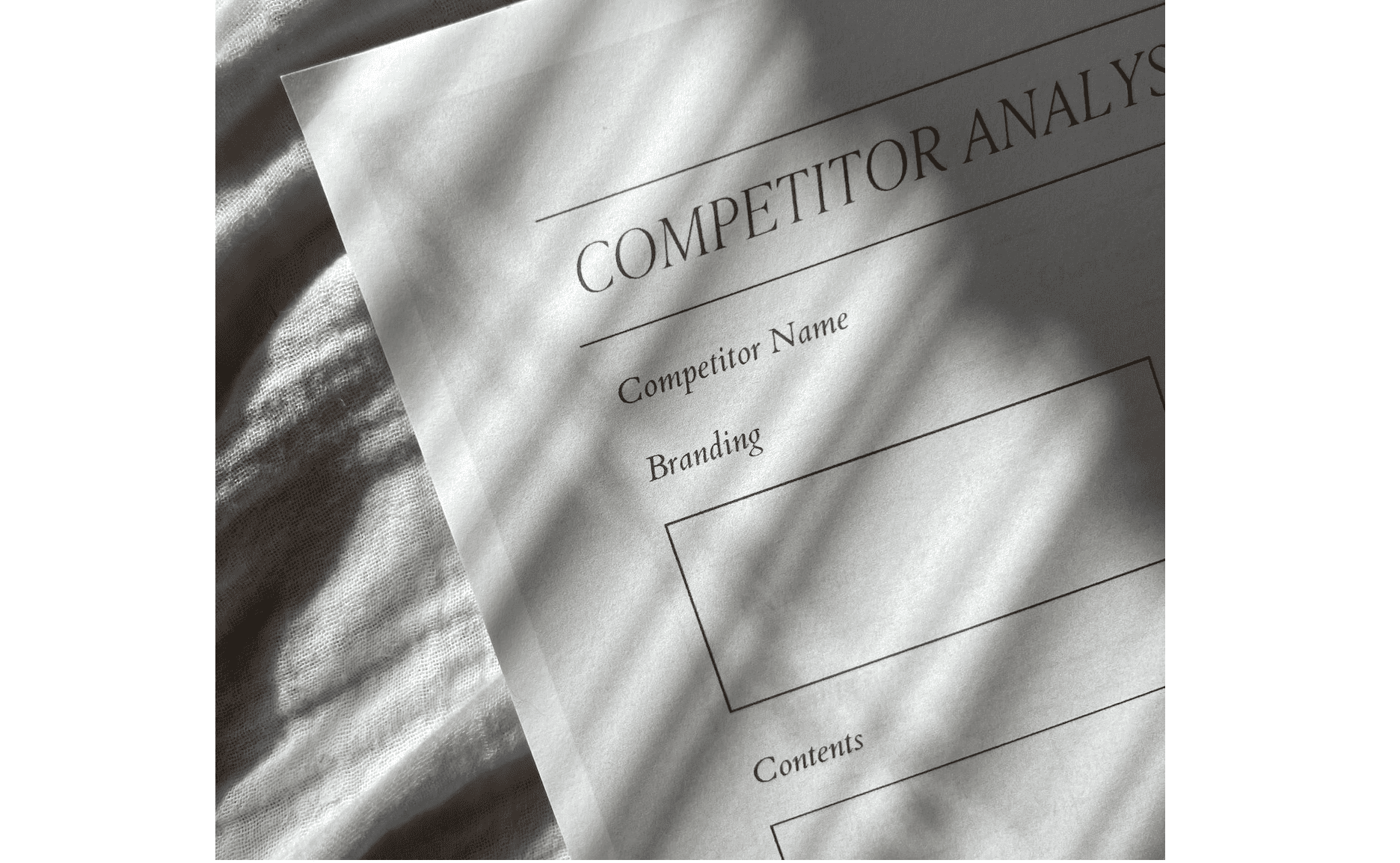 Competitor Analysis paper on top of the bed