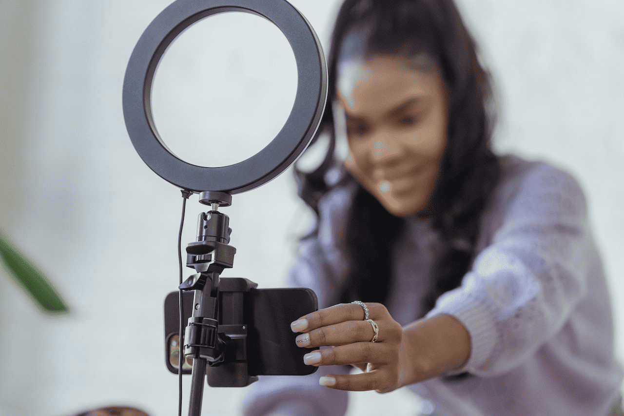 Woman recording on her phone with a ring light stand