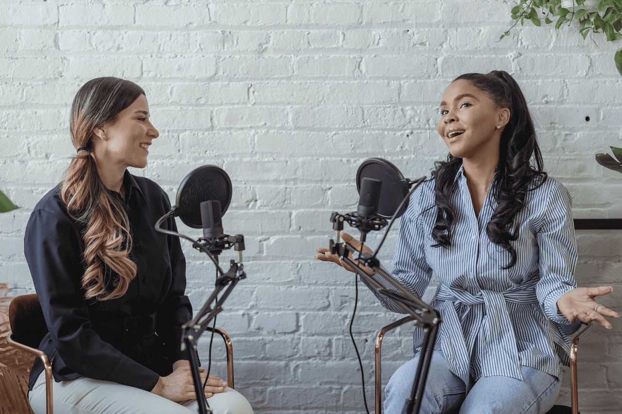 Two woman recording for a podcast and having a conversation