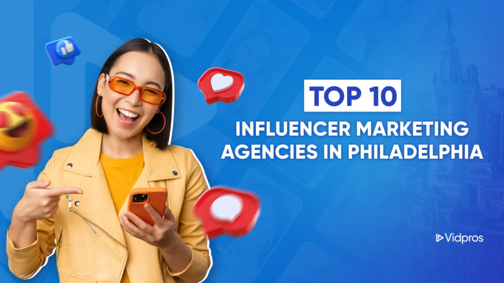 Woman in a yellow jacket and orange sunglasses points to her phone, surrounded by social media icons. Text reads Top 10 Influencer Marketing Agencies in Philadelphia. Perfect for those seeking the best agencies, with a subtle cityscape and Vidpros logo in the background.