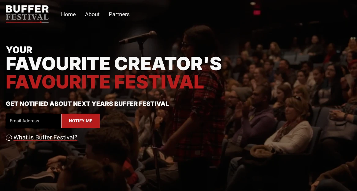 Audience members in a dimly lit theater focus on a person speaking at a microphone. Text overlay reads: Your Favourite Creators Favourite Festival. A call-to-action box for email notifications appears at the bottom.