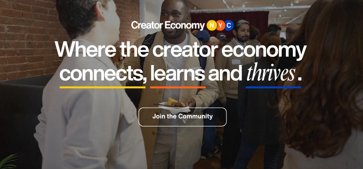 A diverse group of people engaged in conversation at a networking event. The backdrop features a sign reading Where the creator economy connects, learns and thrives with a Join the Community button below.